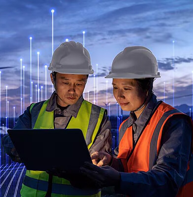 Two engineers in safety suit discussing with an overlay of Openblue graphics